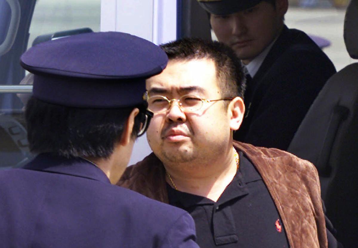 Kim Jong Nam, exiled half brother of North Korea's leader Kim Jong Un, escorted by Japanese police officers at the airport in Narita, Japan on May 4, 2001. (AP Photo/Itsuo Inouye)