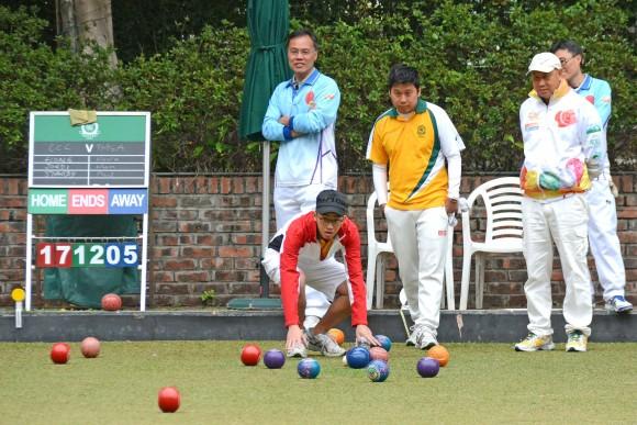 Craigengower Cricket Club's Jordi Lo (in red jacket), anxiously watches his skipper's bowl entering the head. The CCC team hung on to win the match 8:0 and successfully defended their Triples League title. (Stephanie Worth)