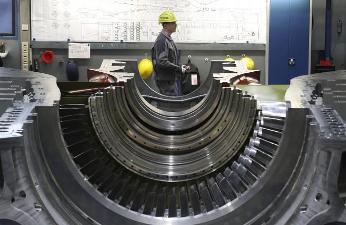 A worker walks past a partially-completed turbine at the Siemens gas turbine factory in Berlin, Germany, on March 2. Germany's number of unemployed fell by 15,000 in February compared to the month before and by 149,000 compared to one year ago. The unemployment rate is currently at 6.3%, which is close to the lowest it has been in 20 years. (Sean Gallup/Getty Images)