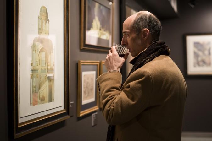 A man looks at a drawing by Irina Shumitskaya at the "Art of Architecture" exhibit at Eleventh Street Arts gallery in Queens, New York, on March 2, 2017. (Samira Bouaou/Epoch Times)