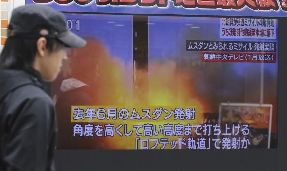 A man walks past a screen showing a TV news on North Korea's missile firing, in Tokyo on March 6, 2017. (AP Photo/Koji Sasahara)