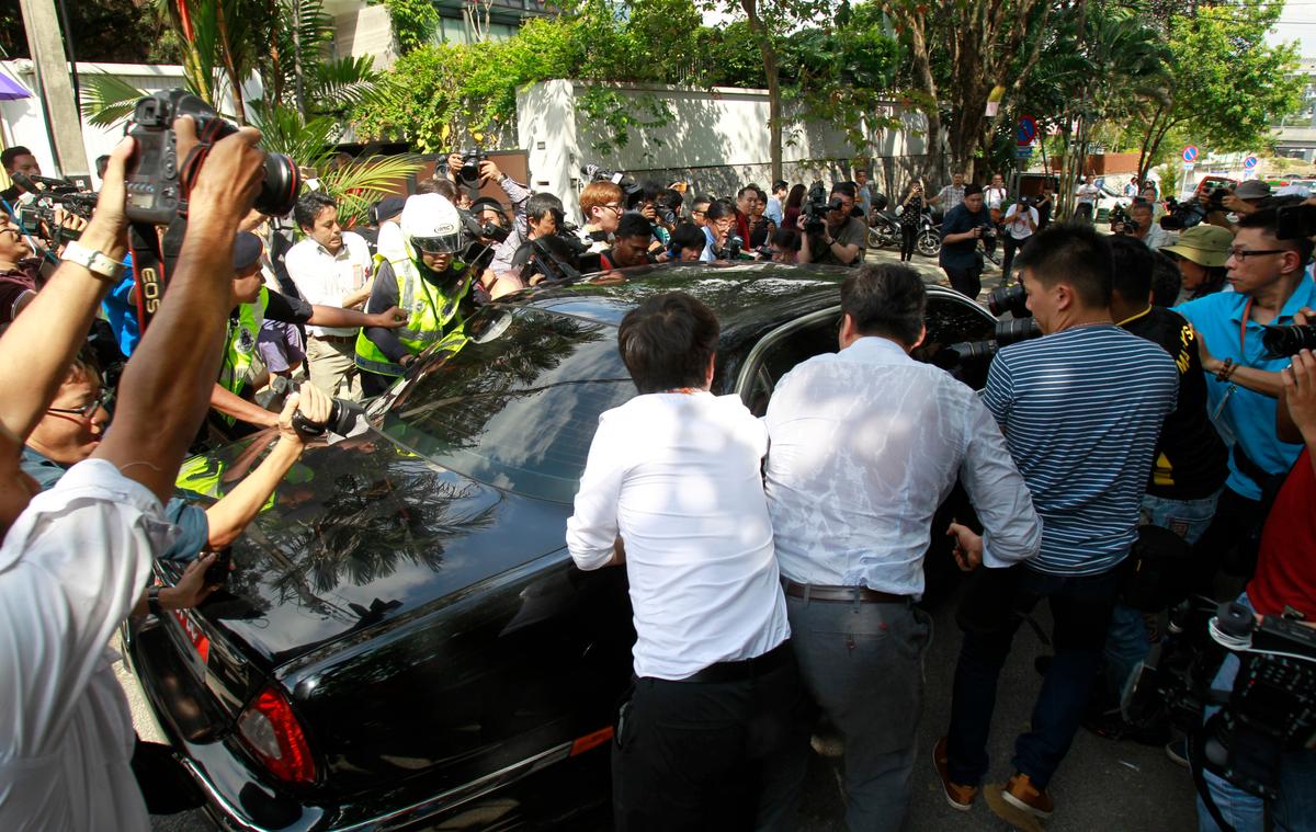 Journalists surround a car of North Korean Ambassador to Malaysia Kang Chol leaving the embassy in Kuala Lumpur, Malaysia on March 6, 2017. (AP Photo/Daniel Chan)