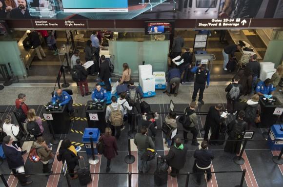 Travelers wait in line at a security screening checkpoint inside the airport terminal at Ronald Reagan Washington National Airport in Virginia, on Dec. 22, 2016. (SAUL LOEB/AFP/Getty Images)