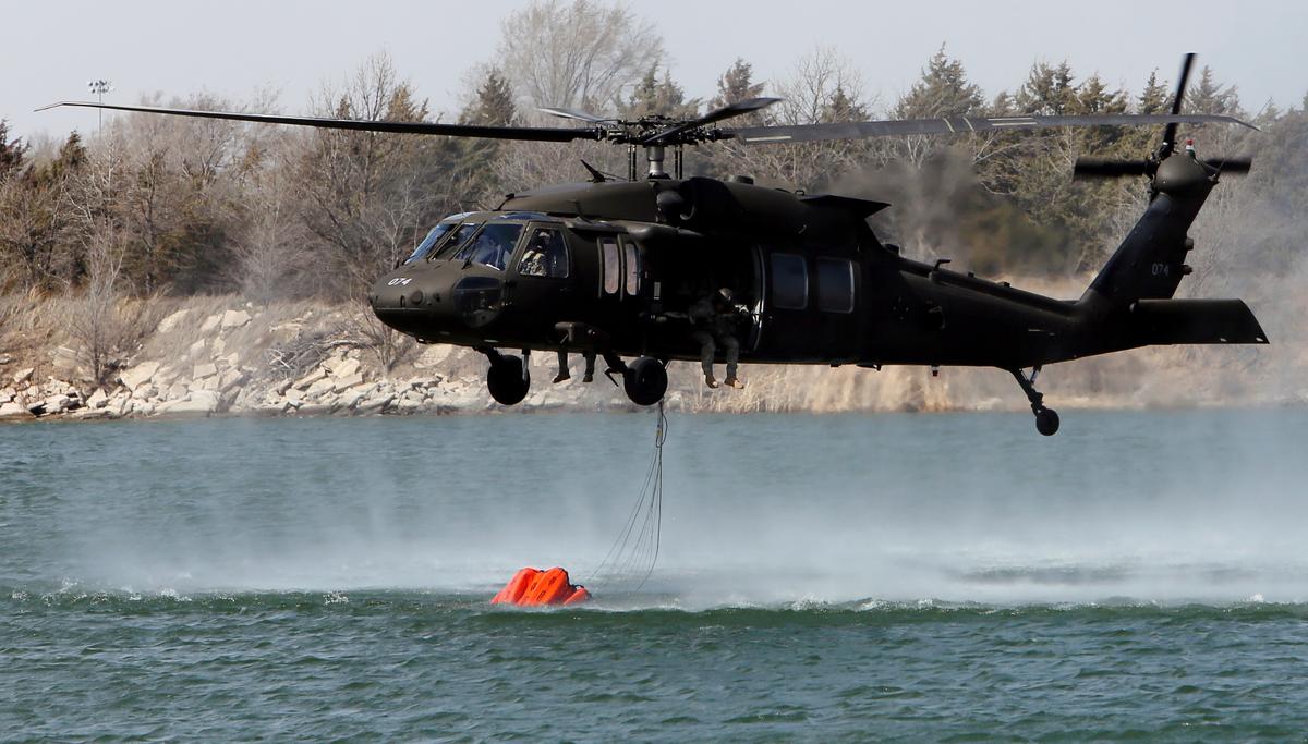 A National Guard helicopter picks up water from the Gravel & Concrete Inc. sandpit in Nickerson, Kan., on March 6, 2017. (Lindsey Bauman/The Hutchinson News via AP)
