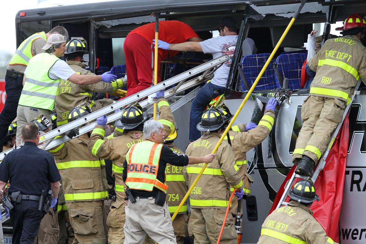 Rescue personnel work to remove passengers from a charter bus that was hit by a CSX train at the Main Street crossing in Biloxi, Miss., on March 7, 2017. ( John Fitzhugh/The Sun Herald via AP)