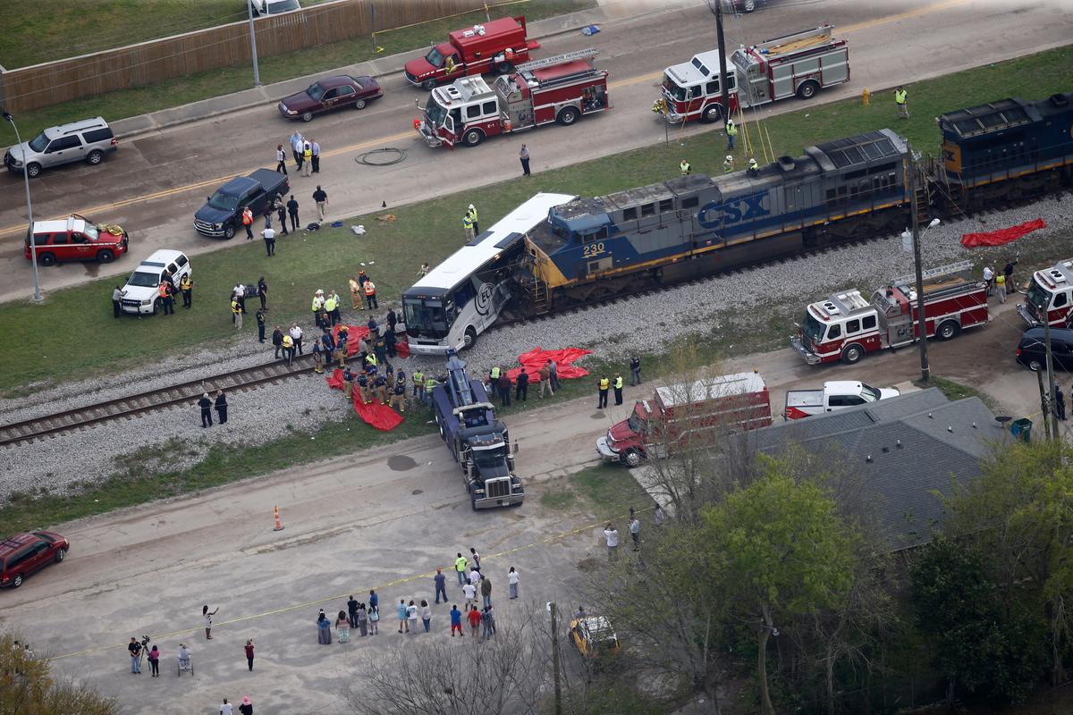 Responders works the scene where a train hit a bus in Biloxi, Miss., on March 7, 2017. (AP Photo/Gerald Herbert)