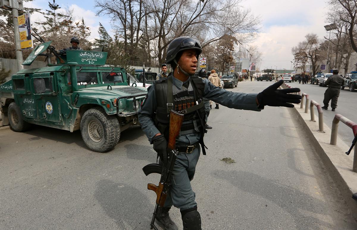 Security forces inspect the site of attack on a military hospital in Kabul, Afghanistan on March 8, 2017. (AP Photo/Rahmat Gul)