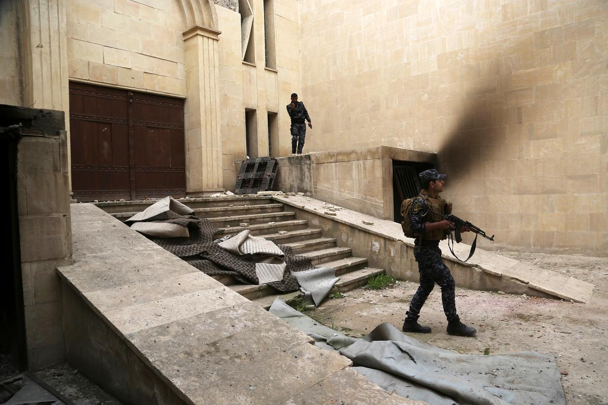 Iraqi federal police inspect Mosul's heavily damaged museum. (AP Photo/Khalid Mohammed)