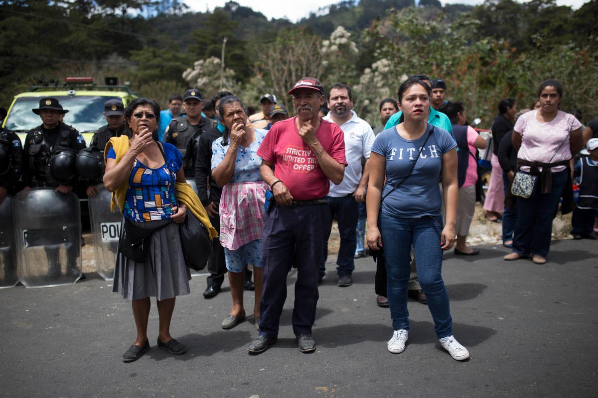 Relatives wait outside the Virgen de la Asunción children's shelter, in San Jose Pinula, Guatemala on March 8, 2017. (AP Photo / Luis Soto)