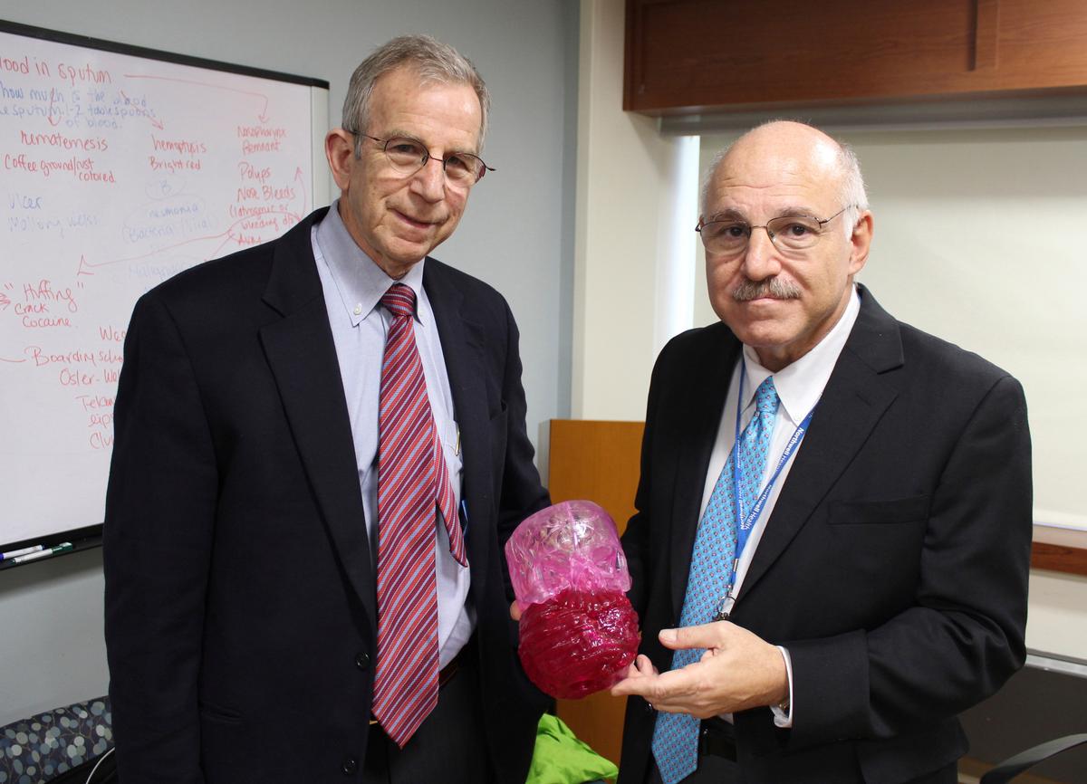 Dr. David Hoffman (L) and Dr. Armen Kasabian, hold a model of a tumor at Cohen's Children's Medical Center in New Hyde Park, N.Y., on March 10, 2017. (AP Photo/Frank Eltman).