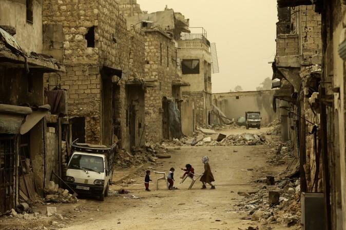 Syrian children play in the once rebel held Karm al-Jabal neighbourhood in Aleppo on March 10, 2017. (Joseph Eid/AFP/Getty Images)