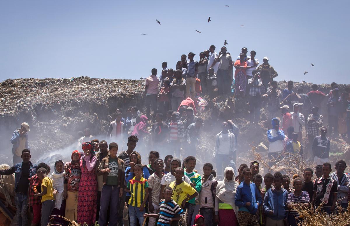 Residents look on as rescue efforts take place at the scene of a garbage landslide, on the outskirts of the capital Addis Ababa, in Ethiopia on March 12, 2017. (AP Photo/Mulugeta Ayene)