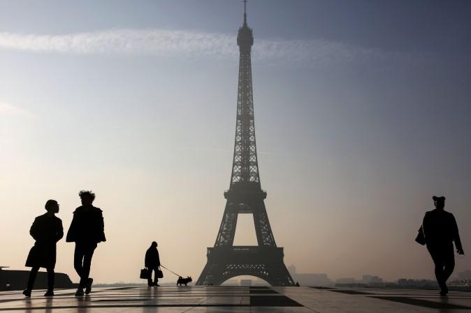 People walk on the Parvis des Droits de l'Homme square near the Eiffel tower in Paris on March 13, 2017. (Ludovic Marin/AFP/Getty Images)