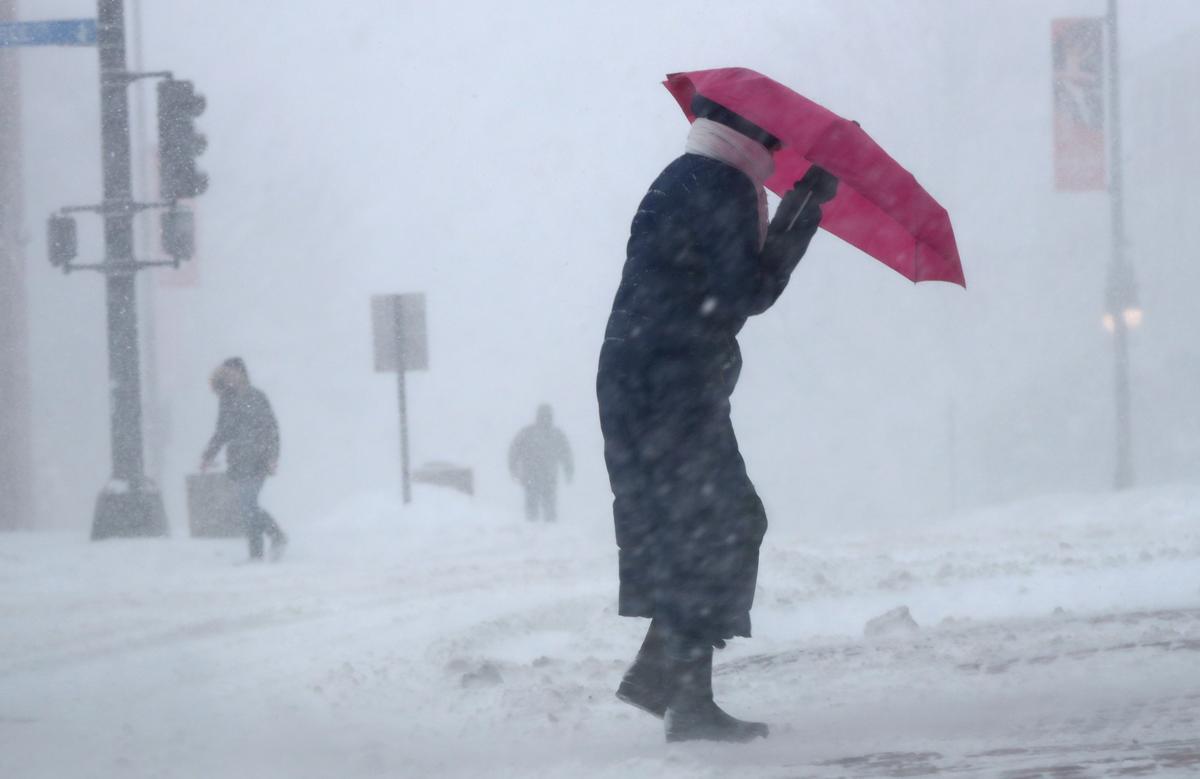 Cherie Burke contends with blowing snow during a blustery storm in Portland, Maine on March 14, 2017. (AP Photo/Robert F. Bukaty)