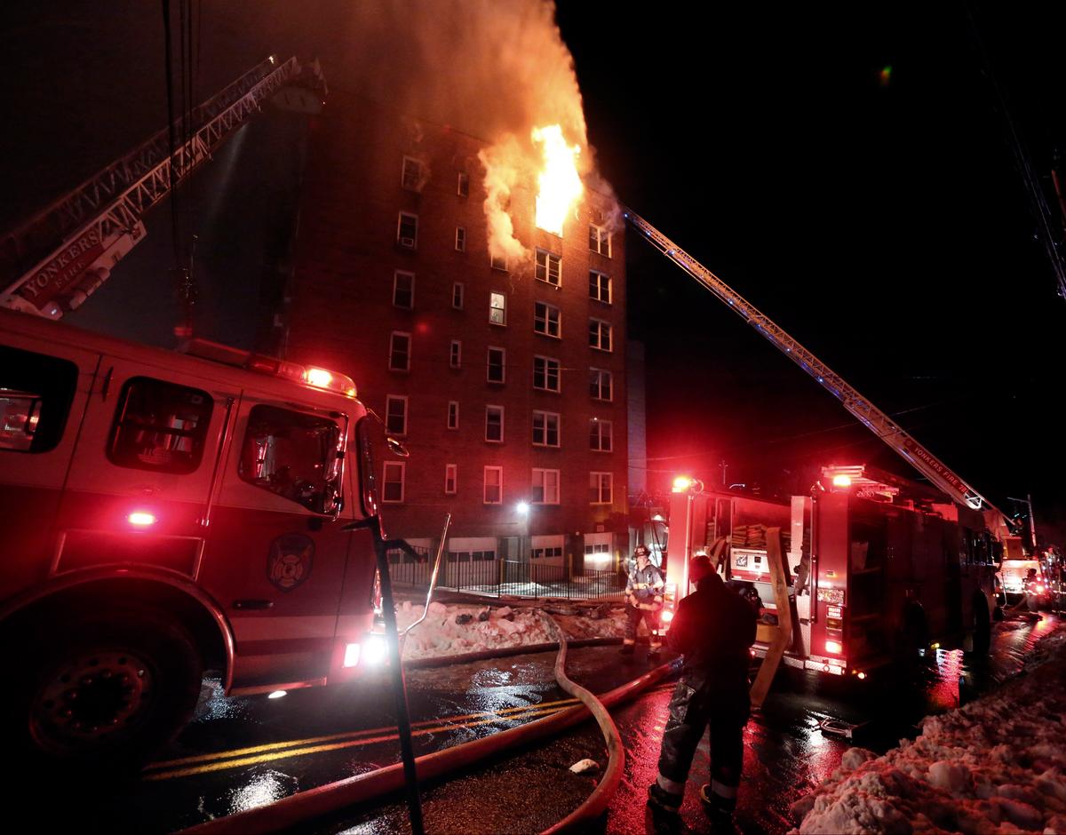 Firefighters battle a fire on the top floor of an apartment building in Yonkers, N.Y., on March 15, 2017. (Mark Vergari/The Journal News via AP)
