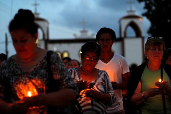 Mothers of missing sons came out of a service of Pedro Alberto Huesca, whose remains were found at one of the unmarked graves where skulls were found on a plot of land, in Palmas de Abajo, Veracruz, Mexico, on March 16, 2017. (REUTERS/Carlos Jasso)