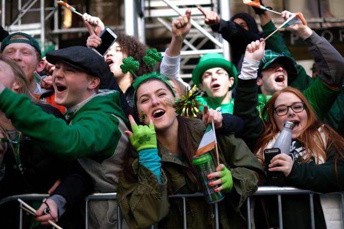 People cheer as participants march on Fifth Avenue during the St. Patrick's Day parade in New York on March 17. (JEWEL SAMAD/AFP/Getty Images)