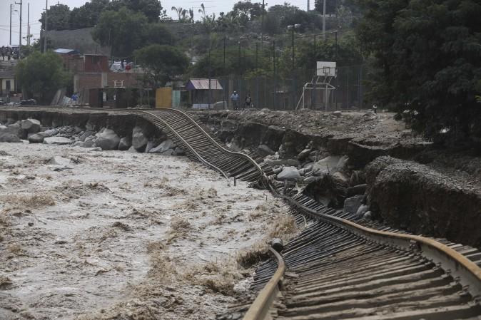 Train tracks are destroyed by a flooded river in the Chosica district of Lima, Peru, on March 19. Intense rains and mudslides over the past three days have wrought havoc around the Andean nation and caught residents in Lima, a desert city of 10 million where it almost never rains, by surprise. (AP Photo/Martin Mejia)