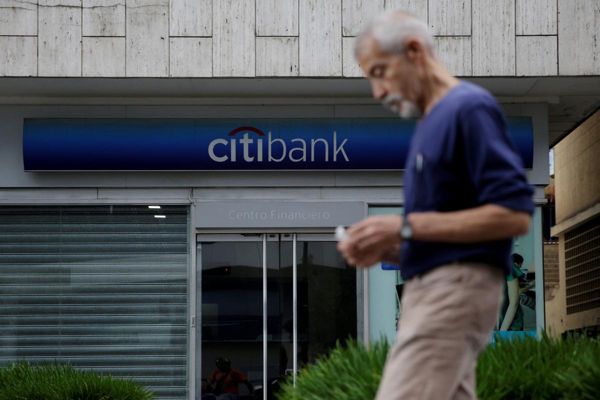 A man walks past a branch of Citi Bank in Caracas, Venezuela on Feb. 14, 2017. (REUTERS/Marco Bello)