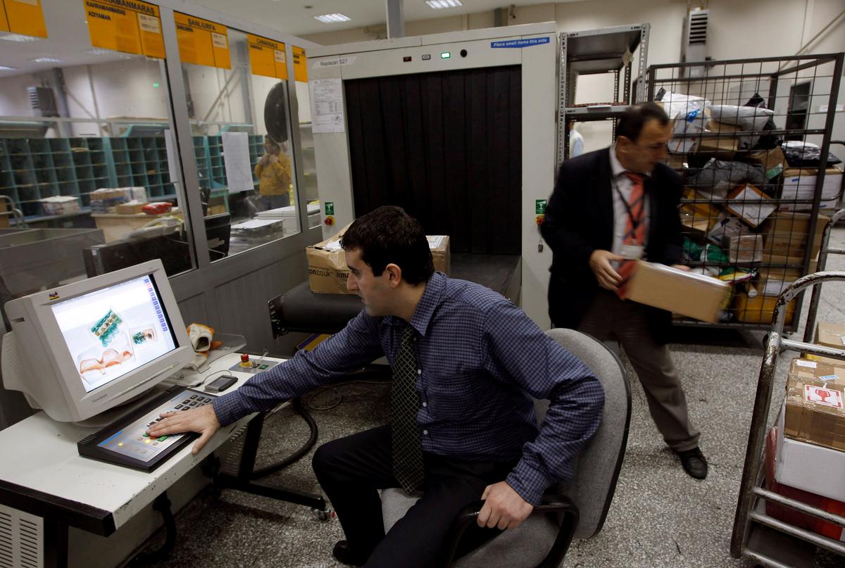 A security official looks at a screen displaying X-ray screened parcels in Turkish Post's (PTT) postal logistic centre at the Ataturk International airport in Istanbul, Turkey on Nov. 6, 2010. (REUTERS/Murad Sezer)