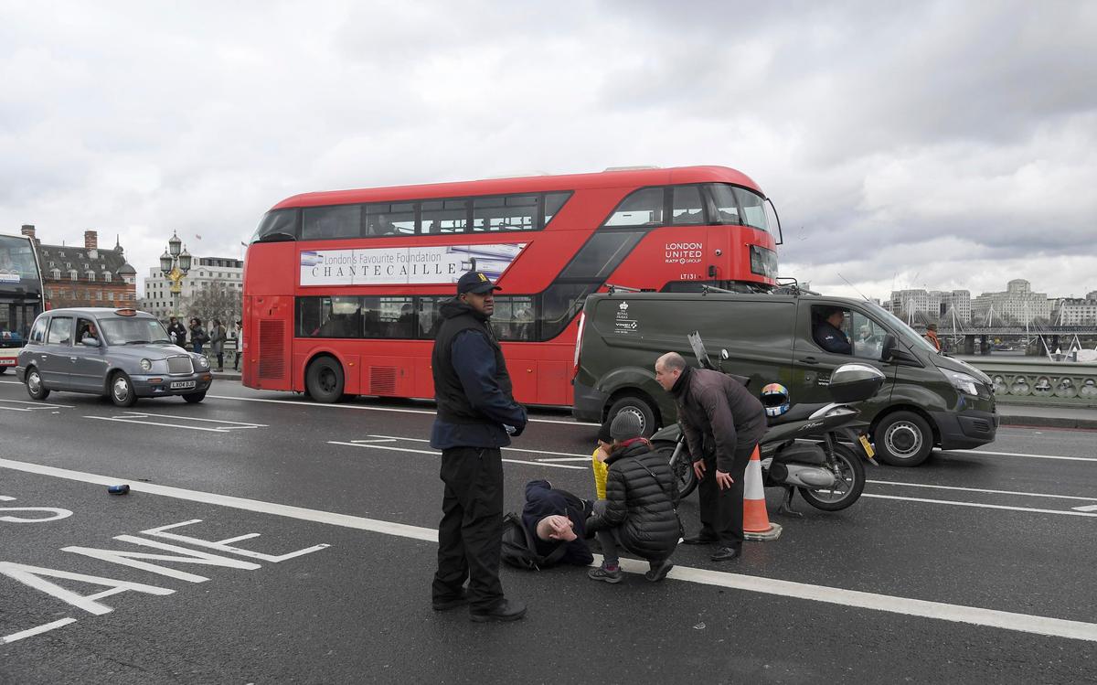 A man lies injured after a shooting incident on Westminster Bridge in London on March 22, 2017. (REUTERS/Toby Melville)