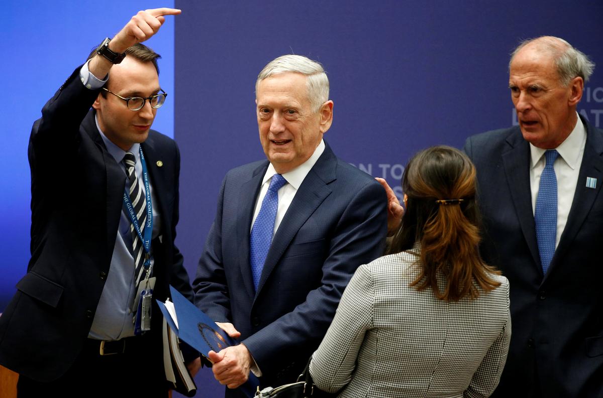 U.S. Secretary of Defense James Mattis (2nd L) is stopped by U.S. Director of National Intelligence Dan Coats (R) during the afternoon ministerial plenary for the Global Coalition working to Defeat ISIS at the State Department in Washington, U.S. on March 22, 2017. (REUTERS/Joshua Roberts)