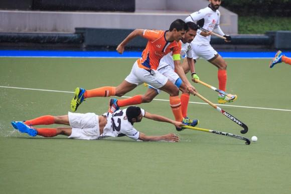 Arshad Mohammad of Khalsa in Orange pushes through to get the ball as SSSC's Mandeep Singh dives to stop him, in the final match of the HKHA Premier League 2016-2017 on March 19, 2017. (Dan Marchant)