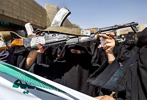 A Yemeni woman brandishes a rifle during a protest in front of the Saudi Embassy in Sanaa on March 18. (MOHAMMED HUWAIS/AFP/Getty Images)