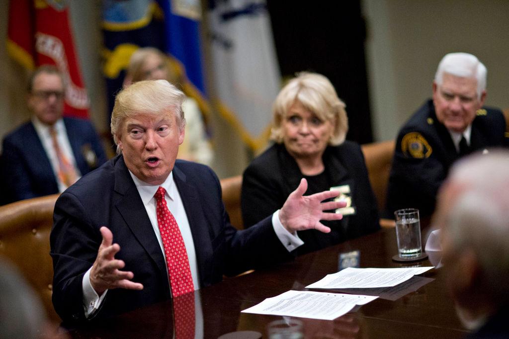 U.S. President Donald Trump speaks as he meets with county sheriffs including Harold Eavenson, sheriff from Rockwall County, Texas (R) and Carolyn Welsh, sheriff from Chester County, Pennsylvania, during a listening session in the Roosevelt Room of the White House in Washington, DC on Feb. 7, 2017. (Andrew Harrer - Pool/Getty Images)