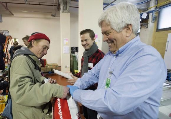 A man receives food from volunteers at the Welcome Hall Mission in Montreal on March 14, 2017. (The Canadian Press/Graham Hughes)