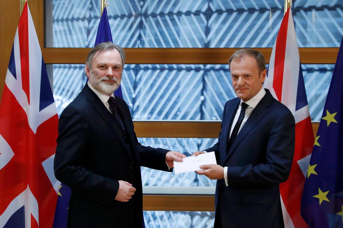 Britain's permanent representative to the European Union Tim Barrow delivers British Prime Minister Theresa May's Brexit letter in notice of the UK's intention to leave the bloc under Article 50 of the EU's Lisbon Treaty to EU Council President Donald Tusk in Brussels, Belgium on March 29, 2017. (REUTERS/Yves Herman)