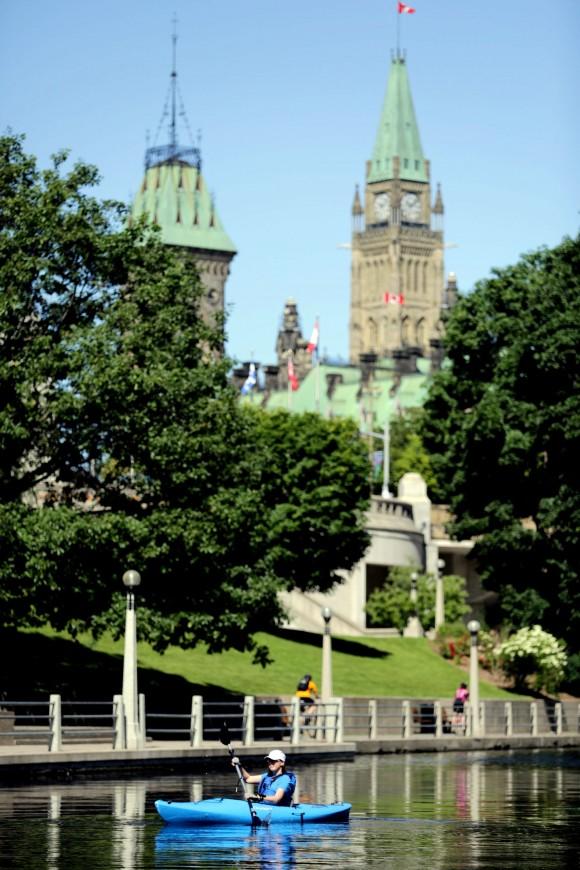 Kayaking past the Parliament Buildings. (Ottawa Tourism)