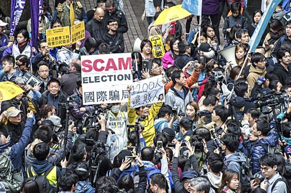 Pro-democracy activists protest outside the venue of the Hong Kong chief executive election in Hong Kong on March 26. (JAYNE RUSSELL/AFP/Getty Images)
