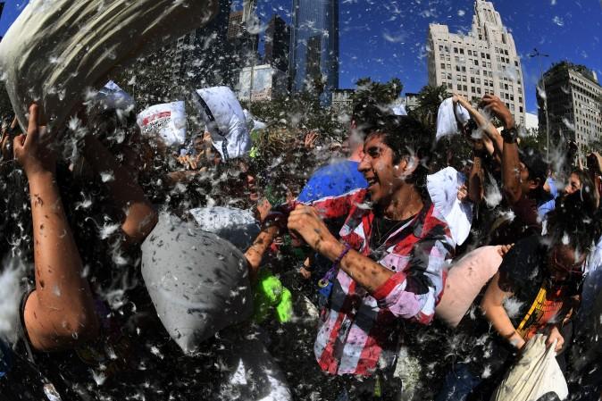 Feathers fly as participants attack each other with pillows during an International Pillow Fight Day event at Pershing Square in Los Angeles on April 1, 2017. (MARK RALSTON/AFP/Getty Images)
