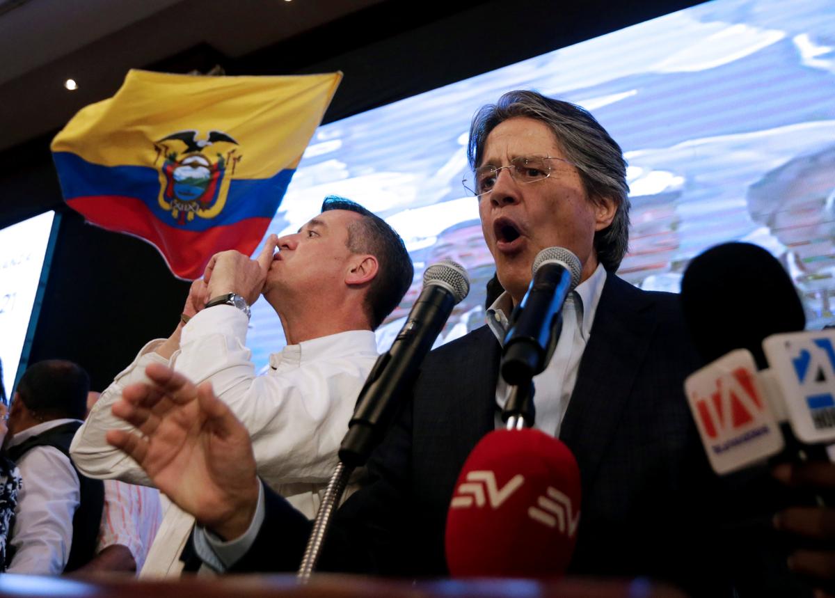Ecuadorean presidential candidate Guillermo Lasso speaks near vice president candidate Andres Paez while waiting for the results of the national election in a hotel in Guayaquil on April 2, 2017. (REUTERS/Mariana Bazo)