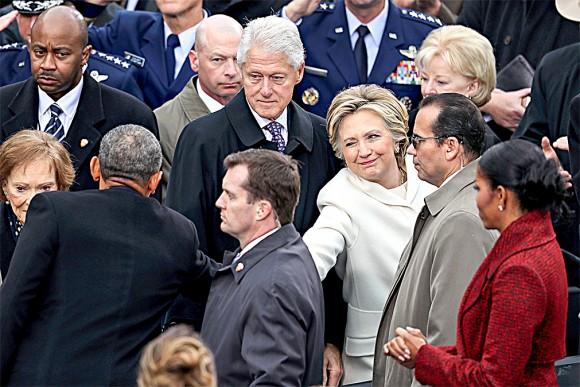Former Democratic presidential nominee Hillary Clinton shakes hands with President Barack Obama as former president Bill Clinton looks on at the West Front of the U.S. Capitol on Jan. 20, 2017. (Joe Raedle/Getty Images)