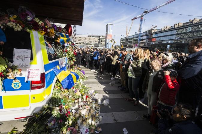 Flowers are left on a police car to show gratitude to law enforcement officers after a peace demonstration on Sergels square in Stockholm, Sweden, on April 9, 2017. An Uzbek man has been arrested and held on terrorism charges following the attack with a hijacked truck which killed four people and injured another 15. (Michael Campanella/Getty Images)