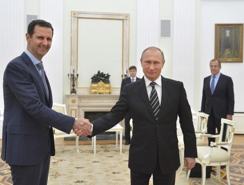 Russian President Vladimir Putin (R) shakes hands with Syrian President Bashar al-Assad during a meeting at the Kremlin in Moscow, Russia on Oct. 20, 2015. (REUTERS/Alexei Druzhinin/RIA Novosti/Kremlin)