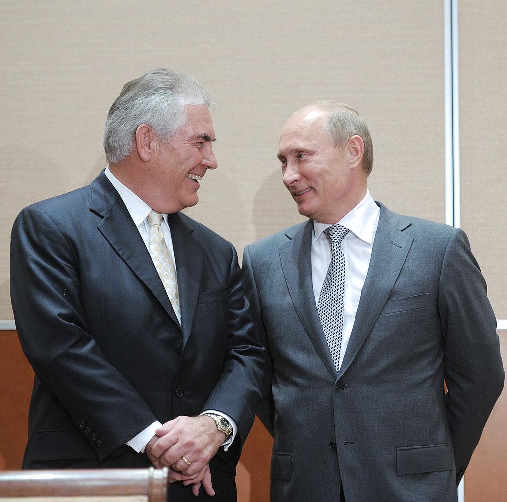 Russia's Prime Minister Vladimir Putin (L) speaks with ExxonMobil President and Chief Executive Officer Rex Tillerson during the signing of a Rosneft-ExxonMobil strategic partnership agreement in Sochi on August 30, 2011. (ALEXEY DRUZHININ/AFP/Getty Images)