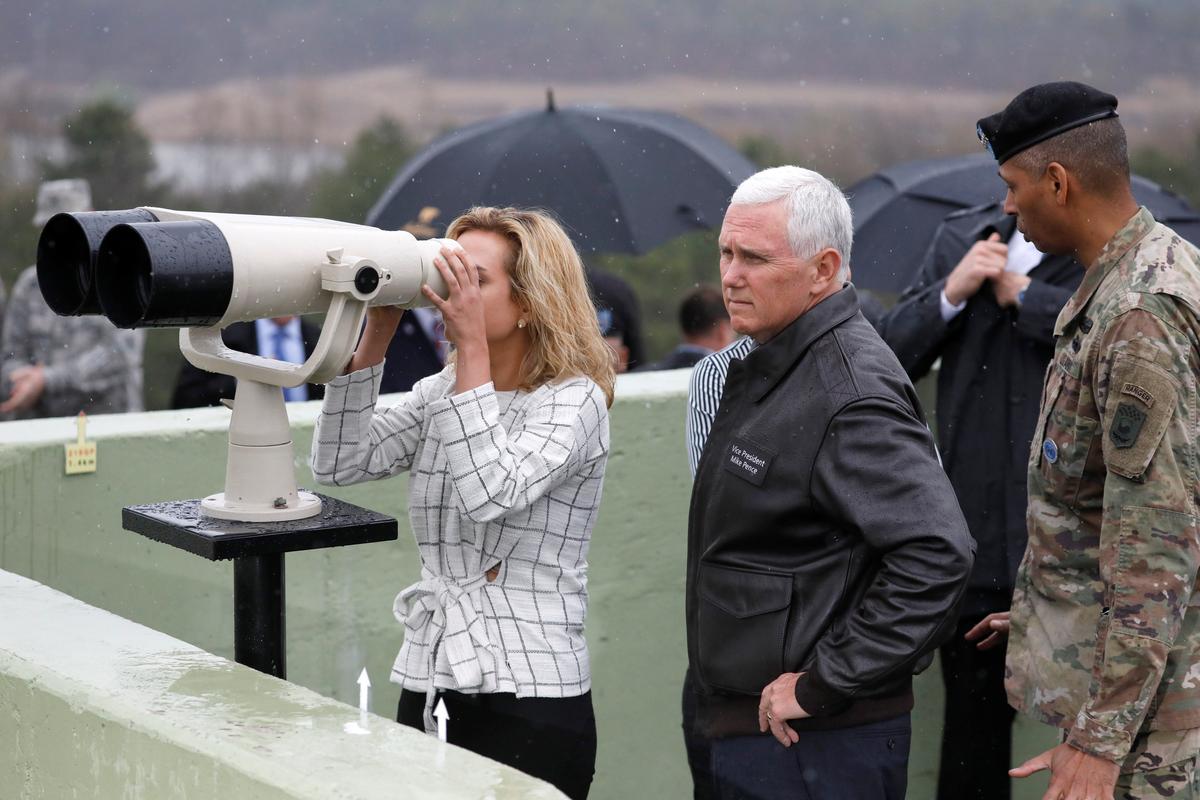 U.S. Vice President Mike Pence stands next to his daughter looking toward the north through a pair of binocular from an observation post inside the demilitarized zone separating the two Koreas, in Paju, South Korea on April 17, 2017. (REUTERS/Kim Hong-Ji)