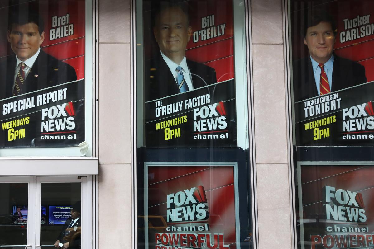 Posters featuring Fox News talent, including Bill O'Reilly, outside the News Corporation headquarters in New York. (REUTERS/Shannon Stapleton)