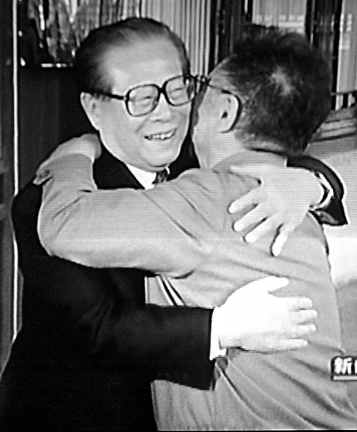 North Korean dictator Kim Jong Il (R) and then-Chinese leader Jiang Zemin embrace during the former's visit to China in April 2004. (CCTV/AFP/Getty Images)