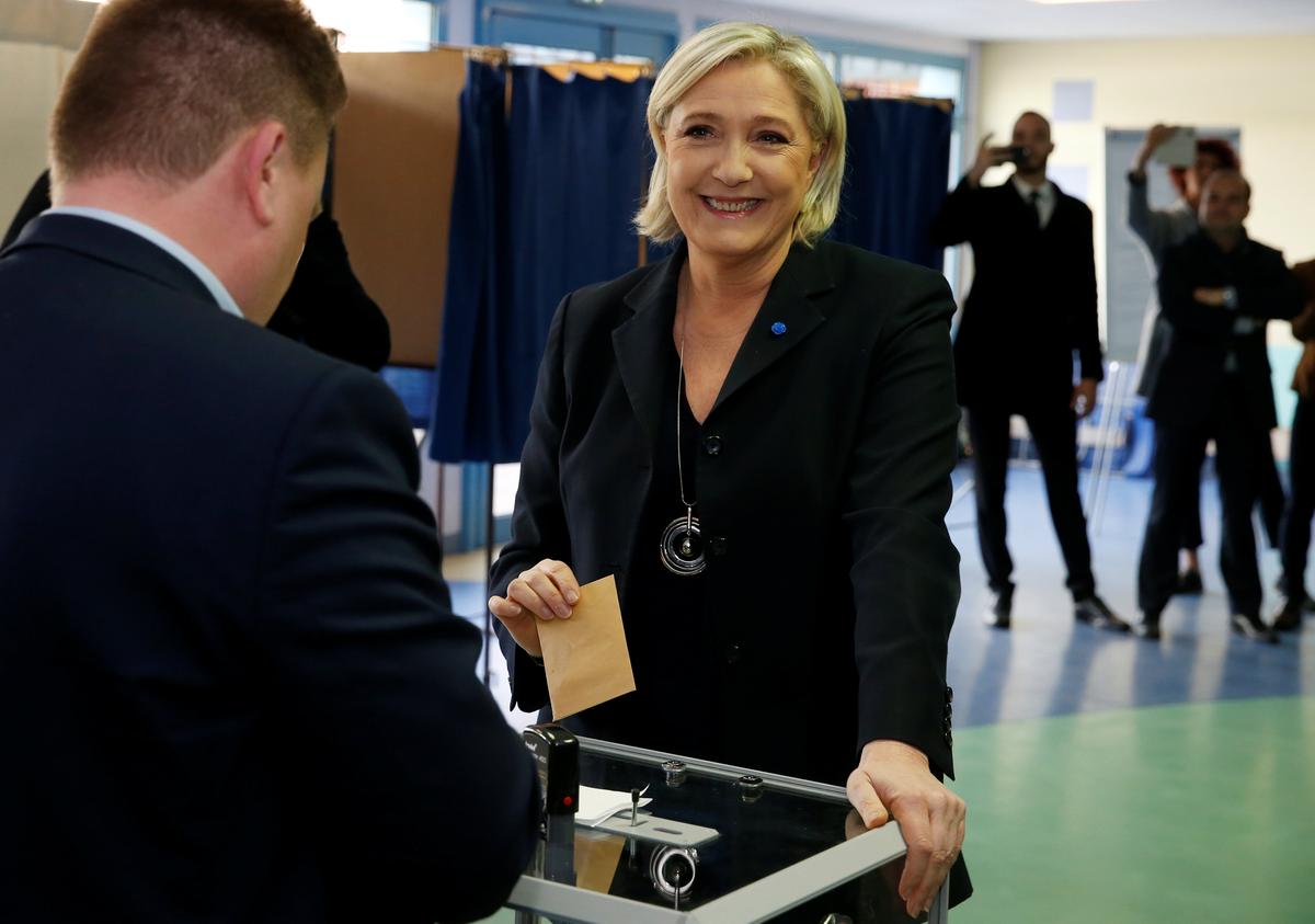 Marine Le Pen, French National Front (FN) political party leader and candidate for French 2017 presidential election, casts her ballot in the first round of 2017 French presidential election at a polling station in Henin-Beaumont, northern France on April 23, 2017. (REUTERS/Pascal Rossignol)