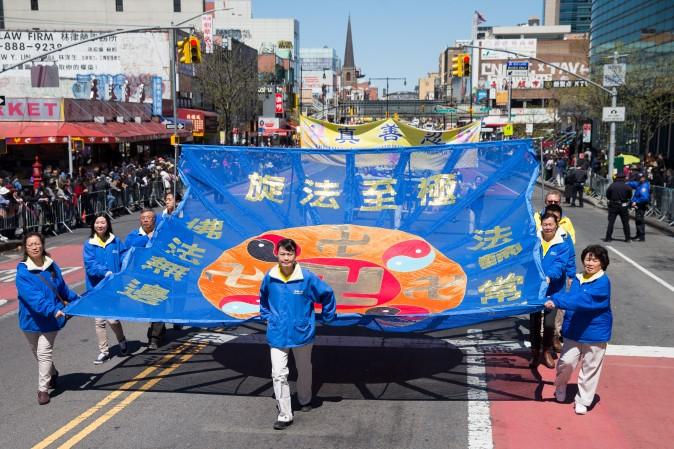 Falun Gong practitioners march in a parade in Flushing, New York, on April 23, 2017, to commemorate the 18th anniversary of the April 25th peaceful appeal of 10,000 Falun Gong practitioners in Beijing. (Larry Dye/The Epoch Times)