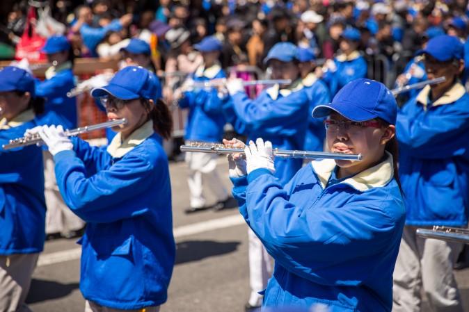 The Tian Guo marching band in a parade in Flushing, New York, on April 23, 2017, to commemorate the 18th anniversary of the April 25th peaceful appeal of 10,000 Falun Gong practitioners in Beijing. (Benjamin Chasteen/The Epoch Times)
