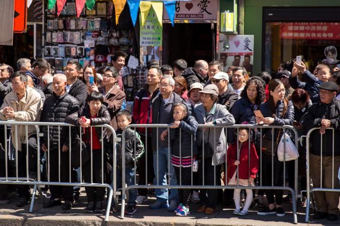 Onlookers at the Falun Gong parade in Flushing, New York, on April 23, 2017, to commemorate the 18th anniversary of the April 25th peaceful appeal of 10,000 Falun Gong practitioners in Beijing. (Benjamin Chasteen/The Epoch Times)