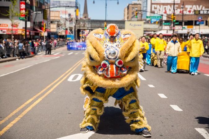 A lion dance team, made up of Falun Gong practitioners, perform in a parade in Flushing, New York, on April 23, 2017, to commemorate the 18th anniversary of the April 25th peaceful appeal of 10,000 Falun Gong practitioners in Beijing. (Benjamin Chasteen/The Epoch Times)