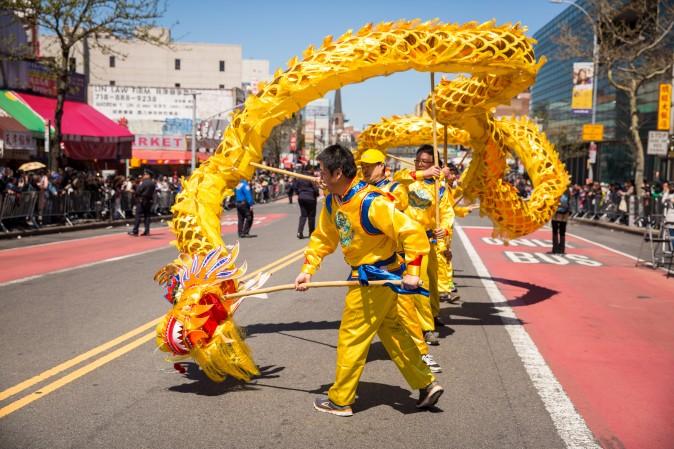 Falun Gong practitioners march in a parade in Flushing, New York, on April 23, 2017, to commemorate the 18th anniversary of the April 25th peaceful appeal of 10,000 Falun Gong practitioners in Beijing. (Benjamin Chasteen/The Epoch Times)