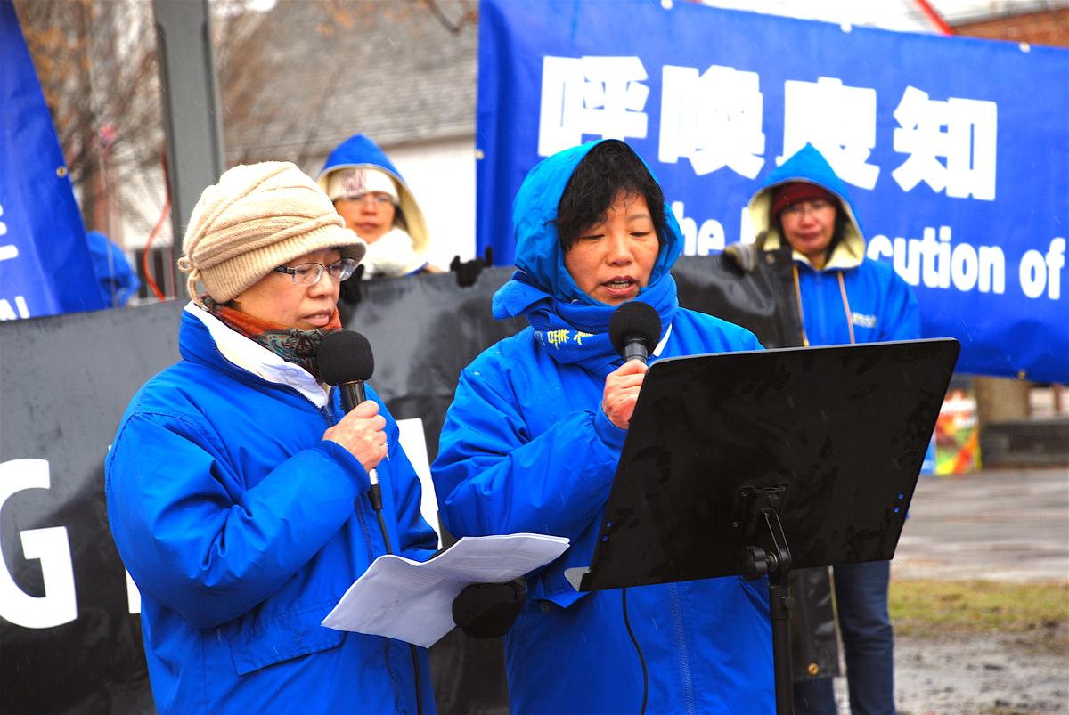 Zhang Ping (R) recounts through a translator how she was imprisoned multiple times in China for practicing Falun Gong at a rally in Edmonton's Dr. Wilbert McIntyre Gazebo on April 22, 2017. The event was held to mark the 18th anniversary of the April 25, 1999 appeal in Beijing by Falun Dafa adherents. (George Qu/The Epoch Times)