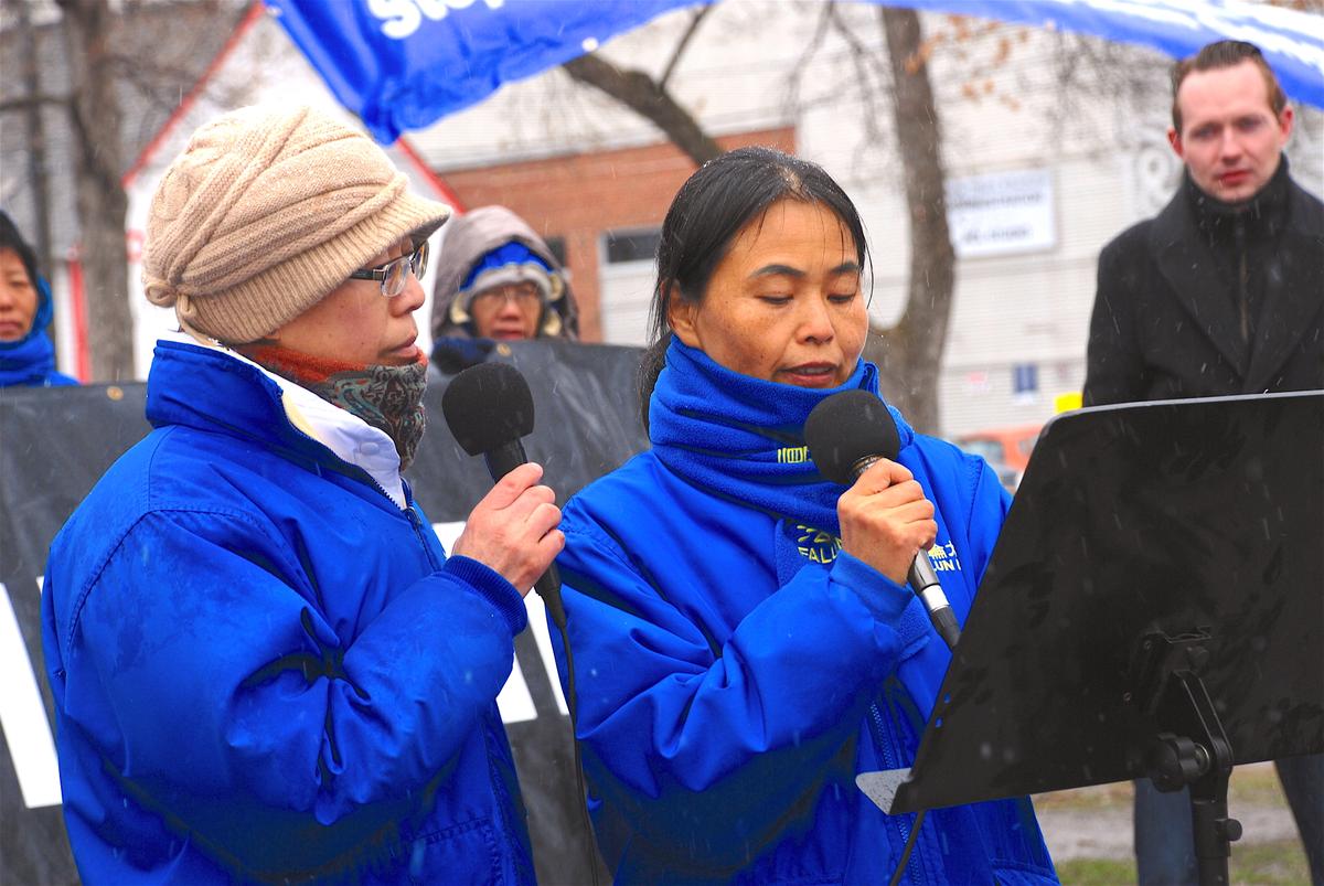 Jiang Hong (R) recounts through a translator how her father fainted under torture and then cremated while still alive in China for practicing Falun Gong at a rally in Edmonton's Dr. Wilbert McIntyre Gazebo on April 22, 2017. The event was held to mark the 18th anniversary of the April 25, 1999 appeal in Beijing by Falun Dafa adherents. (George Qu/The Epoch Times)